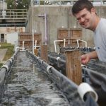 A researcher inspects a water treatment flue