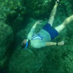 Snorkler dives down